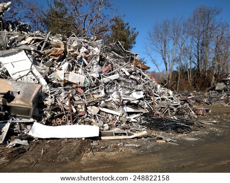 A large pile of scrap metal piled up outside