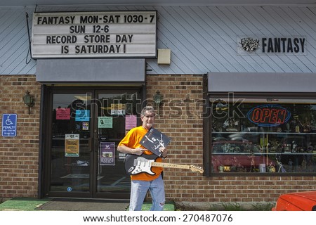 NEWPORT NEWS, VA - APRIL 18, 2015: A man with his vinyl and CD during the 8th annual RSD, Record Store Day, founded in 2007, the third Saturday of April celebrating the independent owned record store