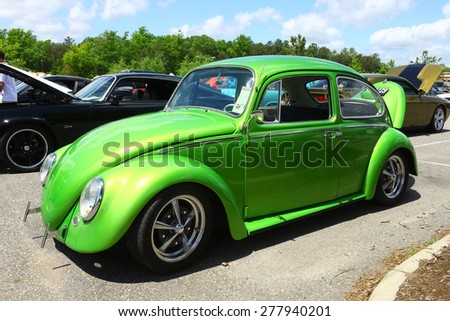 WILLIAMSBURG, VA - May 9, 2015: A lime green Volkswagon Beetle on display at the 6th Annual Project Lifesaver Car Show in Williamsburg Virginia on a summer day.