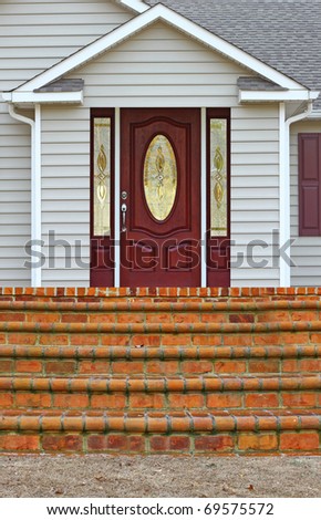 A staircase leading to a porch and a back door entrance to a ranch house with room for your text.