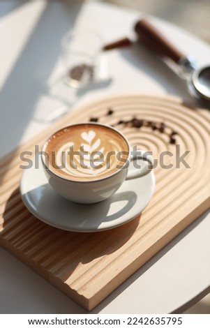 Similar – Image, Stock Photo Cappuccino with latte art on a wooden table in a cafe