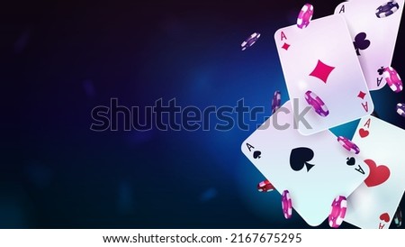 Casino playing cards with poker chips on blue blurred background