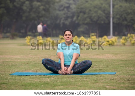 Similar – Image, Stock Photo Barefooted women practicing yoga in mountain pose