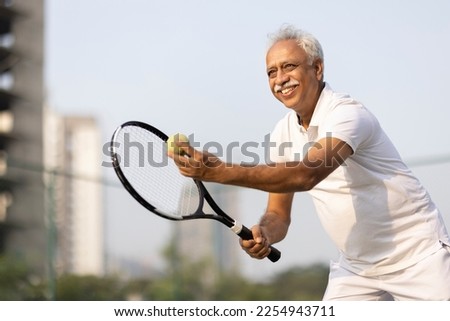 Similar – Image, Stock Photo Senior man playing tennis in gym