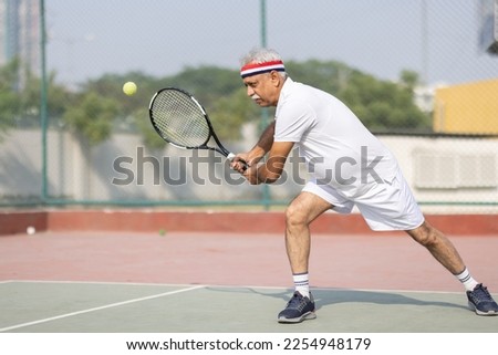 Similar – Image, Stock Photo Senior man playing tennis in gym