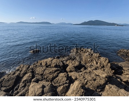 Similar – Foto Bild Felsenküste und friedliches Meer bei Sonnenuntergang