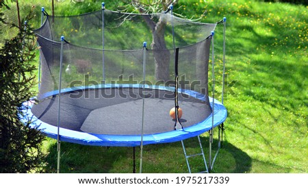 Image, Stock Photo Trampoline on a lawn in the sunset with two kids