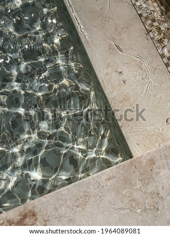 Beautiful view of swimming pool side with clear blue water with sunlight shadow wave reflections. Minimal aesthetic summer vacation concept background Stock foto © 