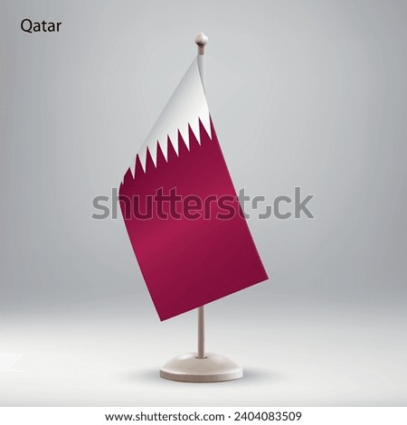 Flag of Qatar hanging on a flag stand. Usable for summit or conference presentaiton