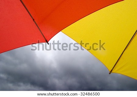 Red and Yellow Umbrellas in the Rain