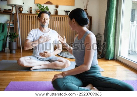 Similar – Image, Stock Photo Calm couple meditating together on mat at home