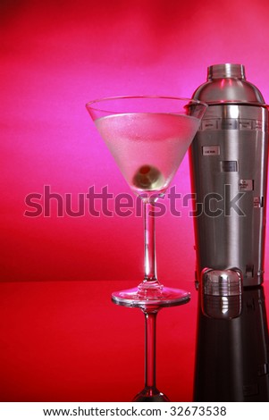 Cold Pink Martini cocktail, olive and stainless steel shaker