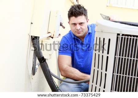 Technician inspects an AC unit