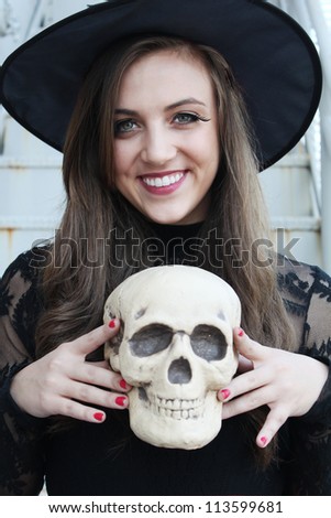 Happy witch with a skull