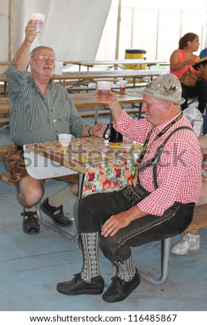 TULSA, OK - OCT 20: Party goers drink beer and sing songs at Oktoberfest in TULSA, OK, on October 20, 2012 in TULSA, OK.  Tulsa is the origin of the Chicken Dance now so popular at the Oktoberfest.