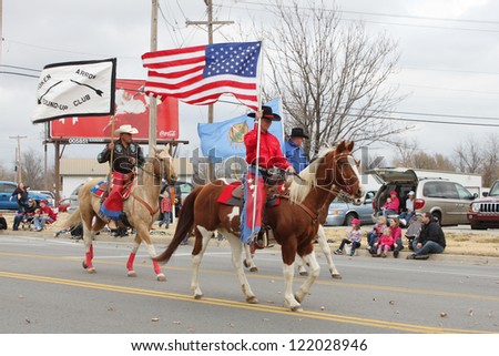 BROKEN ARROW, OK-DECEMBER 8: Horse riders of a local club walk in Christmas Parade in Broken Arrow, Tulsa\'s suburb, on December 8, 2012.