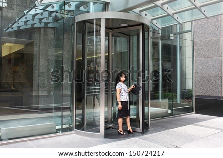 Woman by the door of the hotel, welcoming people in