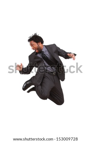 Young man in business suit jumps up high