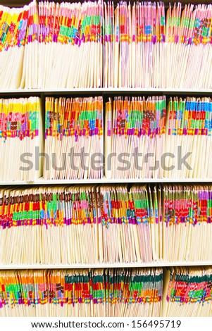 Rows of medical files with colorful tabs