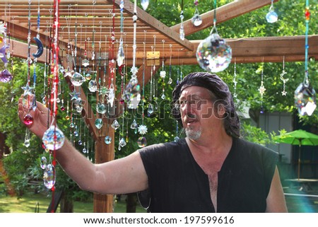 MUSKOGEE, OK - MAY 24: Merchant shows off his crafts for sale at the Oklahoma 19th annual Renaissance Festival on May 24, 2014 at the Castle of Muskogee in Muskogee, OK