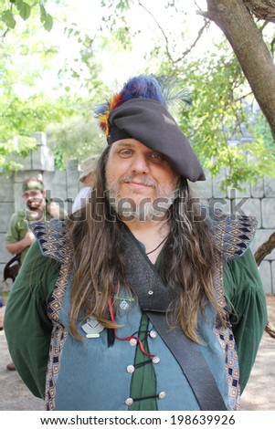 MUSKOGEE, OK - MAY 24: A man dressed as a royal prince stops to talk during the Oklahoma 19th annual Renaissance Festival on May 24, 2014 at the Castle of Muskogee in Muskogee, OK.