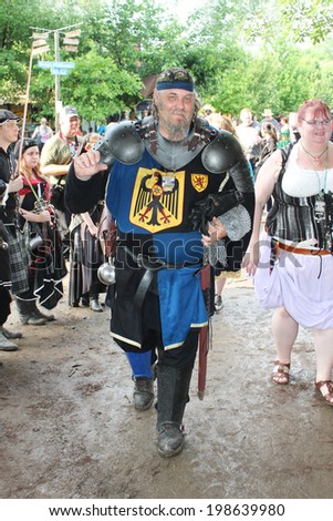MUSKOGEE, OK - MAY 24: A man dressed as a royal knight stops to talk during the Oklahoma 19th annual Renaissance Festival on May 24, 2014 at the Castle of Muskogee in Muskogee, OK.