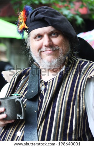 MUSKOGEE, OK - MAY 24: A man dressed as a royal prince stops to talk during the Oklahoma 19th annual Renaissance Festival on May 24, 2014 at the Castle of Muskogee in Muskogee, OK.
