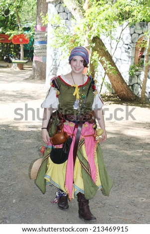 MUSKOGEE, OK - MAY 24: Women dressed in historical costume enjoys her day at the Oklahoma 19th annual Renaissance Festival on May 24, 2014 at the Castle of Muskogee in Muskogee, OK.