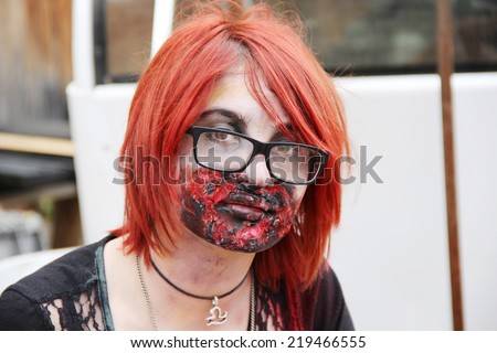 MUSKOGEE, OK - Sept. 13: A bloody female zombie looks for runners during the Castle Zombie Run at the Castle of Muskogee in Muskogee, OK on September 13, 2014.