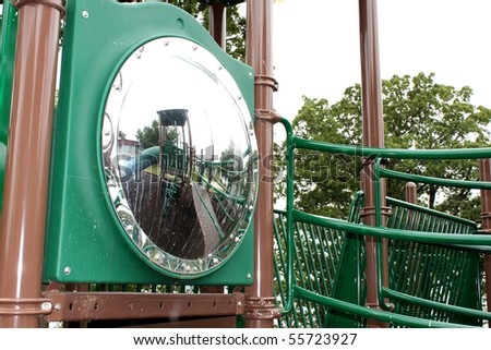 Empty playground reflecting in a dirty mirror