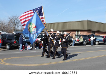 BROKEN ARROW, OK-DECEMBER 4: Broken Arrow Police members proudly carry American and Oklahoma flags to open Christmas Parade on December 4, 2010.