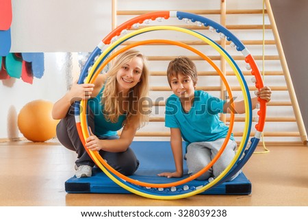 Happy, sports family, mother and son perform gymnastic exercises.