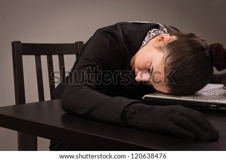 Detective scene imitation. Lifeless woman in a black suit sitting on a table