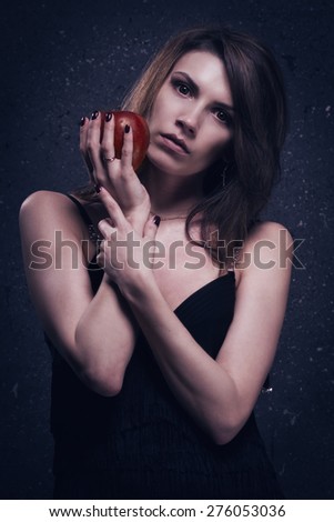 Asylum. Lonely mad woman with red apple. Low key.