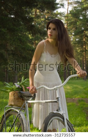Happy young beautiful woman with retro bicycle, summer outdoor