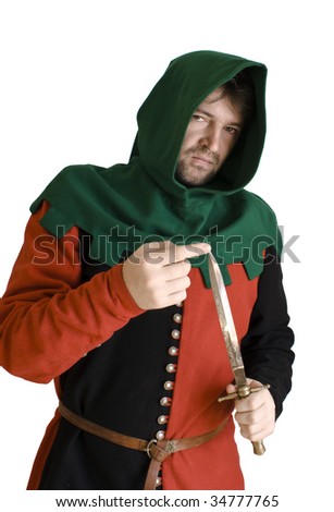 Medieval robber in an ancient red and black suit checks an edge of a knife