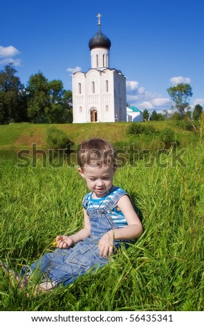 Little boy on a  orthodox church background. Church of the Intercession on the Nerl, Vladimir region of Russia