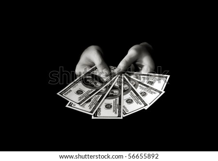 Hands with packs of dollars over black