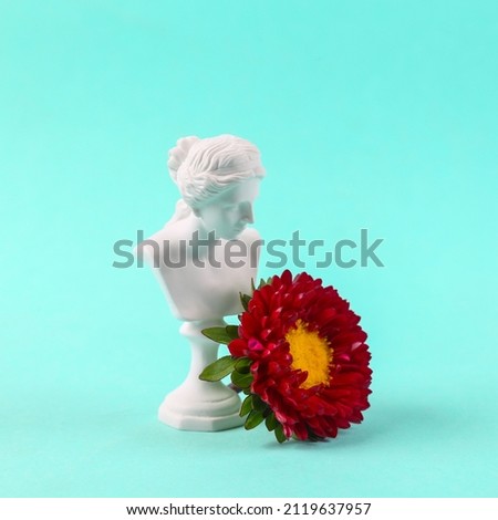 Plaster bust of venus with a flower on blue background. Stok fotoğraf © 