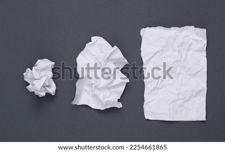 Image, Stock Photo ball of crumpled gray paper on a blue background