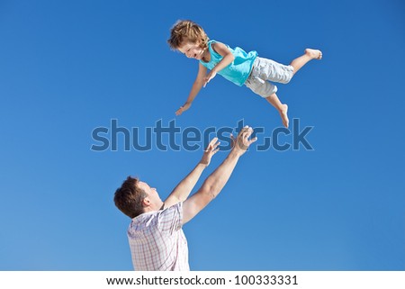 happy father and son playing on sky background