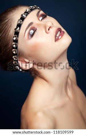Glamorous female portrait close-up. Fashion evening elegance shine to the eyes and lips. Eye makeup model. Cosmetics and makeup
