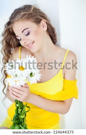 Portrait of happy smiling beautiful young woman with bouquet flowers