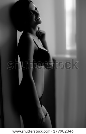 Black and white silhouette of young, sporty and sexy woman in lingerie
