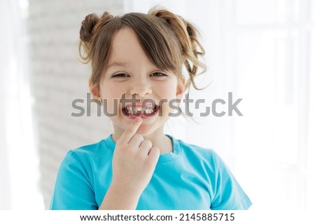 Similar – Image, Stock Photo Toothless girl smiling for camera