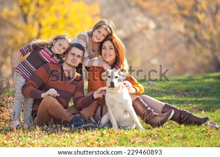Happy family with dog on nature