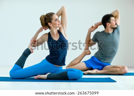 Young healthy couple in yoga position