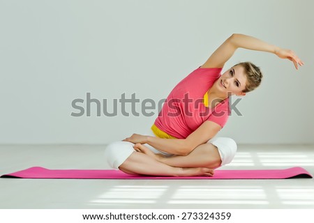Young woman in the Pigeon yoga pose. Series