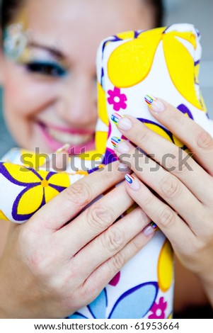 A beautiful woman\'s hand with a manicure and brightly painted nails