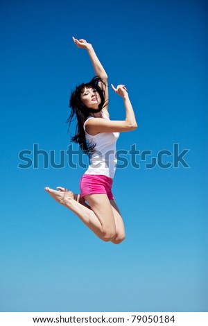 Young beautiful girl doing gymnastick jump